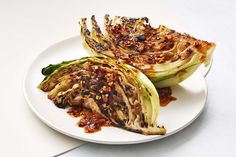 two pieces of artichoke sitting on top of a white plate