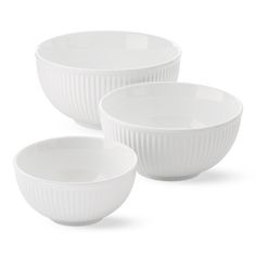 three white bowls sitting next to each other