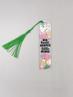 a bookmark with tassels and writing on it that says, big hearts shape minis