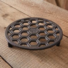 a cast iron grate sitting on top of a wooden table