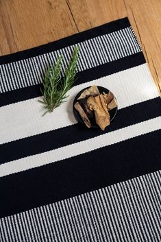 a black and white table cloth with a small plate of food on top of it