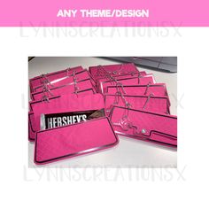 pink binders with nameplates on them sitting next to a keyboard