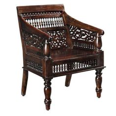 an ornate wooden chair with turned legs