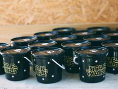 many black cups with star wars designs on them