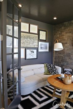 a living room filled with furniture and pictures on the wall