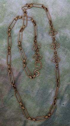 Solid vintage brass chain and daisy links with solid brass hammered hook clasp. At 32" long it can be wrapped to wear as a choker or long to give a cool hip vibe. Sunlit 4 Luxury Brass Box Chain Necklace, Brass Chain Link Necklace With Lobster Clasp, Vintage Brass Link Necklace, Handmade Adjustable Brass Chain Necklace, Handmade Long Brass Chain Necklace, Bronze Adjustable Chain Brass Necklace, Bronze Brass Chain Necklace With Adjustable Chain, Bronze Adjustable Chain Necklace In Brass, Bronze Brass Adjustable Chain Necklace