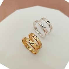 two rings with names on them sitting next to each other