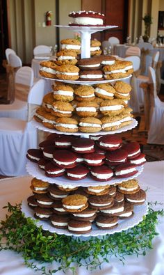 a tower of cookies and pastries on top of each other at a wedding reception