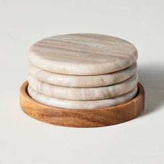 four white marble coasters stacked on top of each other