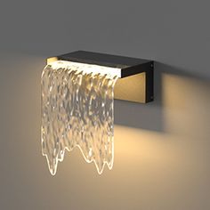 a wall light that is on the side of a wall with water running down it