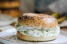 a close up of a bagel on a plate with other plates in the background