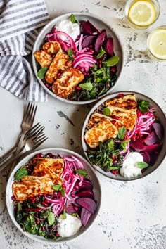 three bowls filled with chicken, onions and greens