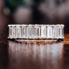 a diamond ring sitting on top of a wooden table