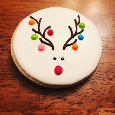 a decorated christmas cookie on a wooden table