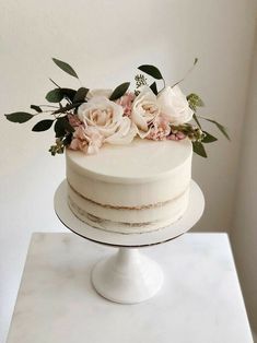 there is a white cake with flowers on top