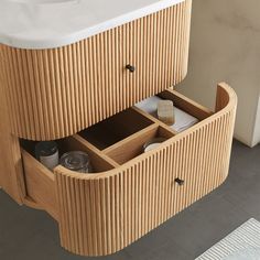 a bathroom with a sink and wooden cabinet