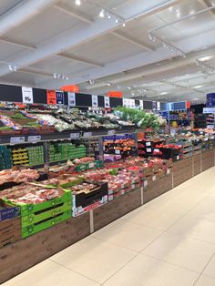 an empty grocery store filled with lots of fresh produce and meats on display for sale