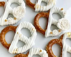 several pretzels decorated with white frosting and flowers