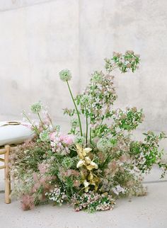 a vase filled with lots of flowers next to a surfboard