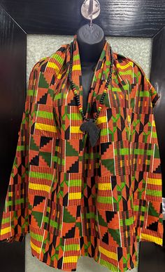 This is a African Kente cloth Print shawl and necklace combination. The length is 72 inches and with is 25 inches . This is unisex and has endless possibilities. It can be worn as a shawl, stole a table runner, a large head wrap , a sarong and so much more . The choice is yours . Its 100 % cotton and  machine washable . This is a light weight fabric . Don't delay order  yours today. Men Shawl, African Scarf, Kente Cloth, Women Shawl, Head Wrap, Sarong, Endless Possibilities, Head Wraps, Ghana