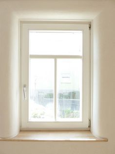 an empty window in a white room