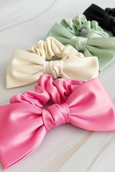 Our Satin Bow Tie Hair Scrunch is made from high quality satin, this scrunchie adds a charming and sophisticated detail to any hairstyle. Perfect for both casual and formal events, this scrunch is a must-have for a polished and stylish appearance.Dimensions: The bow is approximately 5.5" x 3" x 1"Made In: ChinaMaterial Composition: high quality satin Bow Scrunchie Hairstyles, Scrunchies Design, Satin Hair Accessories, Small Products, Bow Tie Hair, Diy Hair Scrunchies, Classy Blouses, Tie Hair, Hair Bonnet