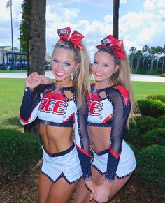 two cheerleaders are posing for the camera