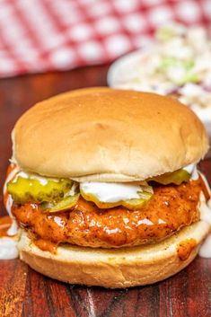 a chicken sandwich with pickles and mayonnaise