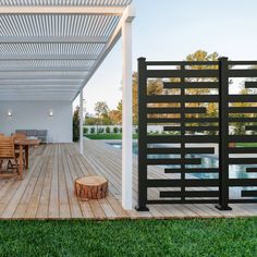 an outdoor dining area with wooden table and chairs