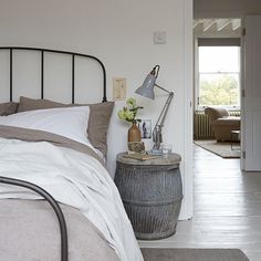 a bed sitting in a bedroom next to a doorway