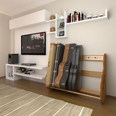 a living room filled with furniture and a flat screen tv mounted on a wall next to a book shelf