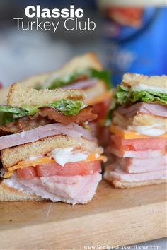 a club sandwich with ham, cheese and lettuce cut in half on a cutting board