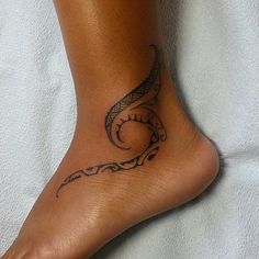 a woman's foot with a tattoo design on the top and bottom of it