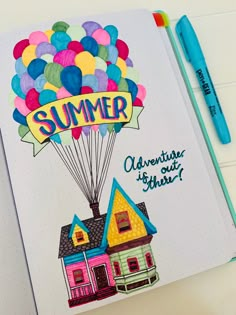 an open notebook with a drawing of a house and balloons in the shape of a balloon