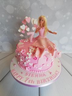 a birthday cake with a barbie doll on top