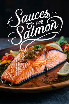 salmon on a plate with sauces for salmon written in cursive writing above it