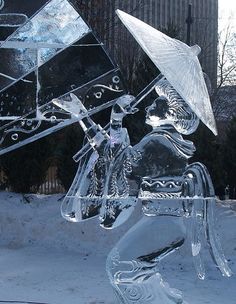 an ice sculpture of a man riding a horse holding an umbrella in the snow,