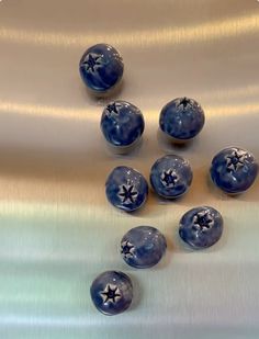 some blue and white balls on a silver surface