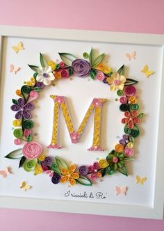 the letter m is made out of paper flowers