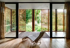 an open living room with wooden shutters and sliding glass doors