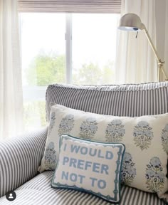 a bed with two pillows and a pillow that says i would prefer not to