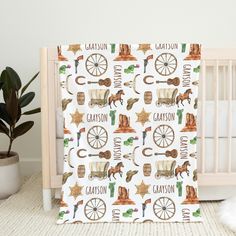 a baby crib bedding set with horses, wagons and other things on it