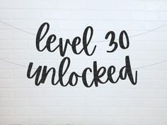 a sign that says level 10 unlocked on a white brick wall with black writing underneath it