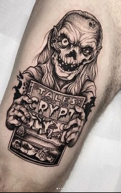 a man's leg with a tattoo on it that has a creepy clown holding a sign