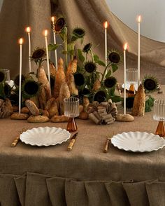 the table is set with bread and sunflowers for an elegant dinner or party