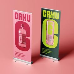 two advertising signs on pink and green with the number six in front of them, one for camu