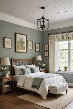 a bed sitting in a bedroom next to a window with pictures on the wall above it