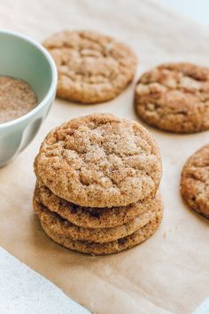 several cookies and a cup of coffee on a paper towel next to some brown sugar