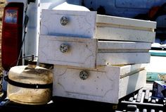 an old chest of drawers sitting on the back of a truck