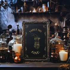 a table topped with candles and bottles filled with liquid next to a sign that says table no one